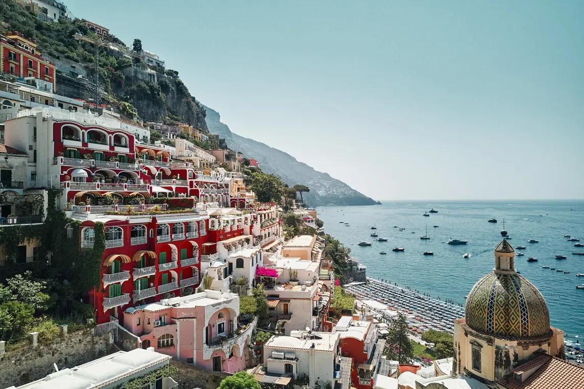 Pastel houses of Positano stacked down the cliffside toward the sea